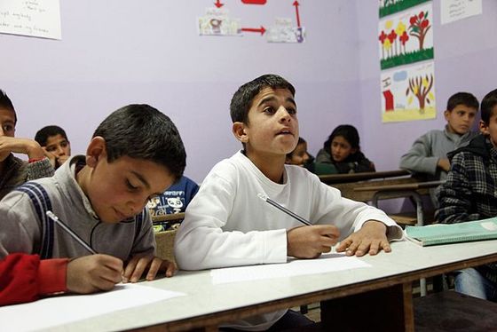 <i>Two 11-year-old refugees from Syria, 2013</i>. Photograph by UK Department for International Development / Wikimedia Commons